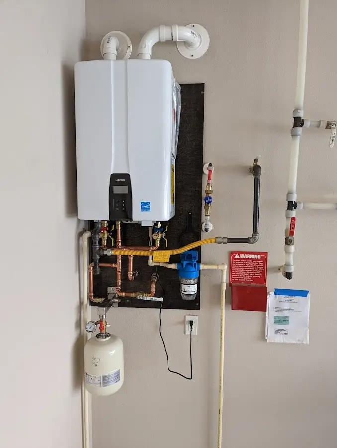 Professional plumber installing copper piping in a Millersville home